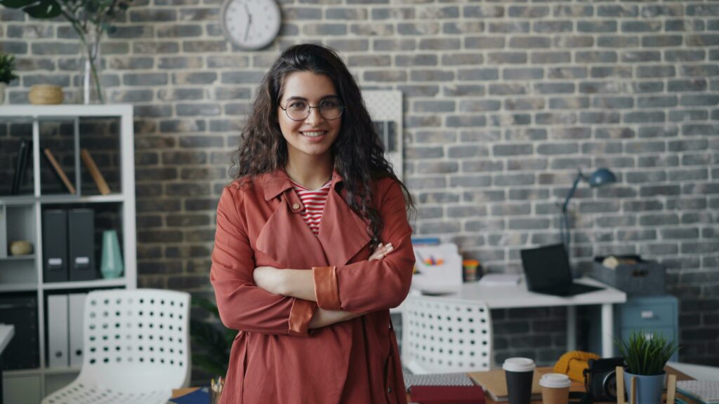 woman standing in office with arms crossed